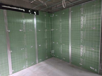 Rigid insulation boards fixed to the underside of a concrete soffit slab
